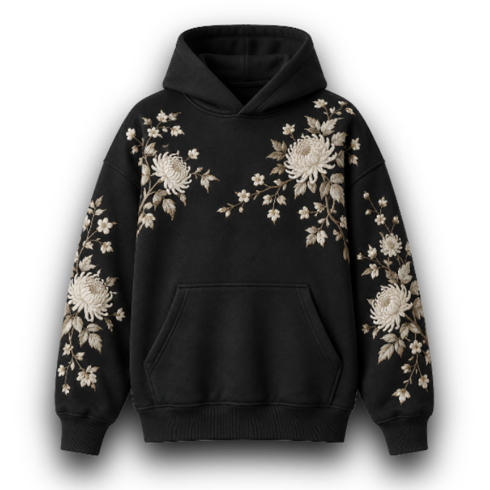 A black pullover hoodie featuring intricate white and beige floral embroidery on the chest and both sleeves, displayed against a plain white background. 